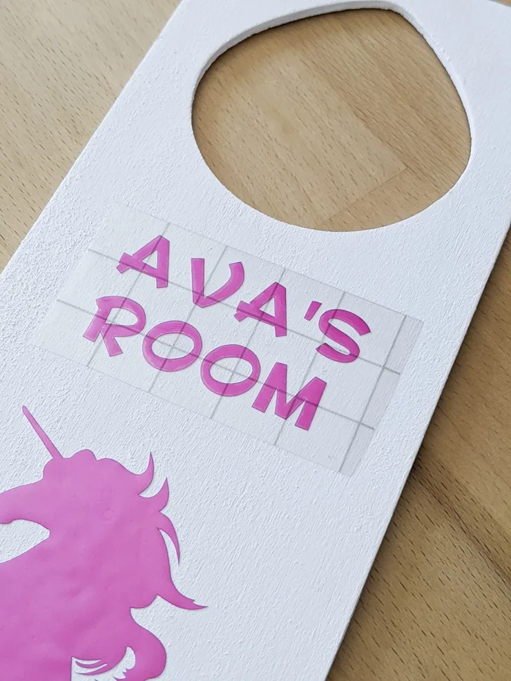 applying vinyl to make a diy door knob hanger for a kids room