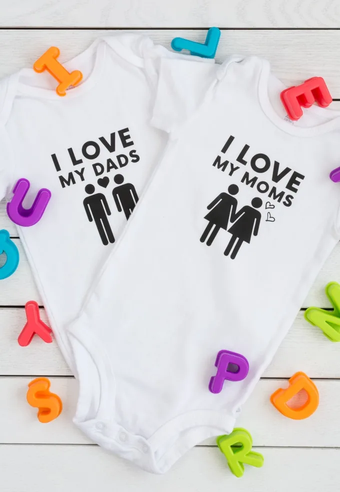 baby bodysuits made using a Cricut Explore Air 2 that say I love my moms and I love my dads