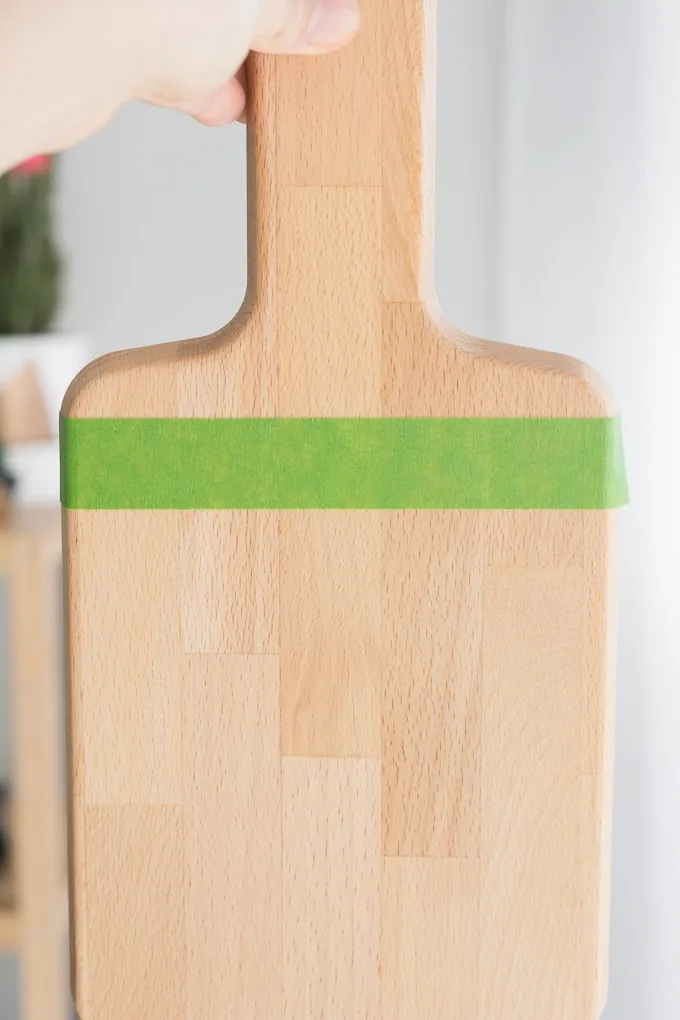 applying painter's tape to the cutting board