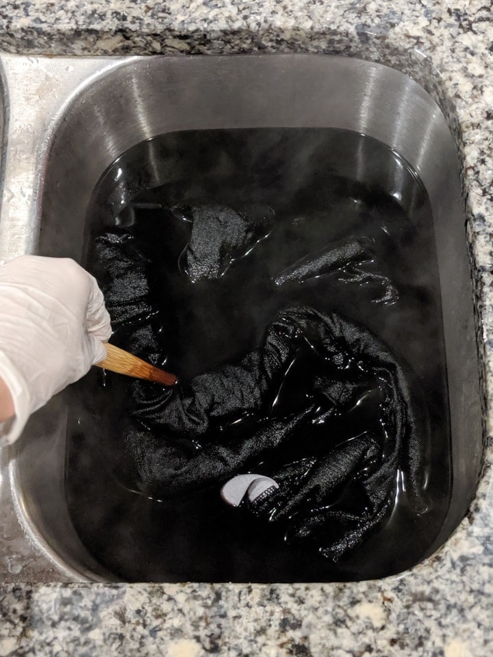 dress submerged in the black dye bath