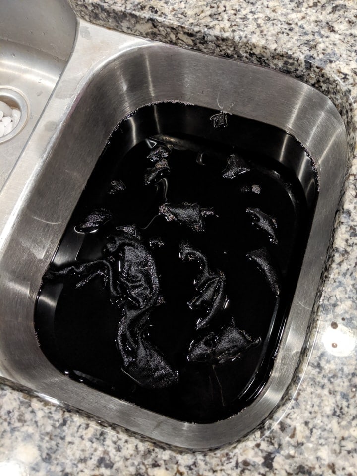 dress submerged in the black dye bath
