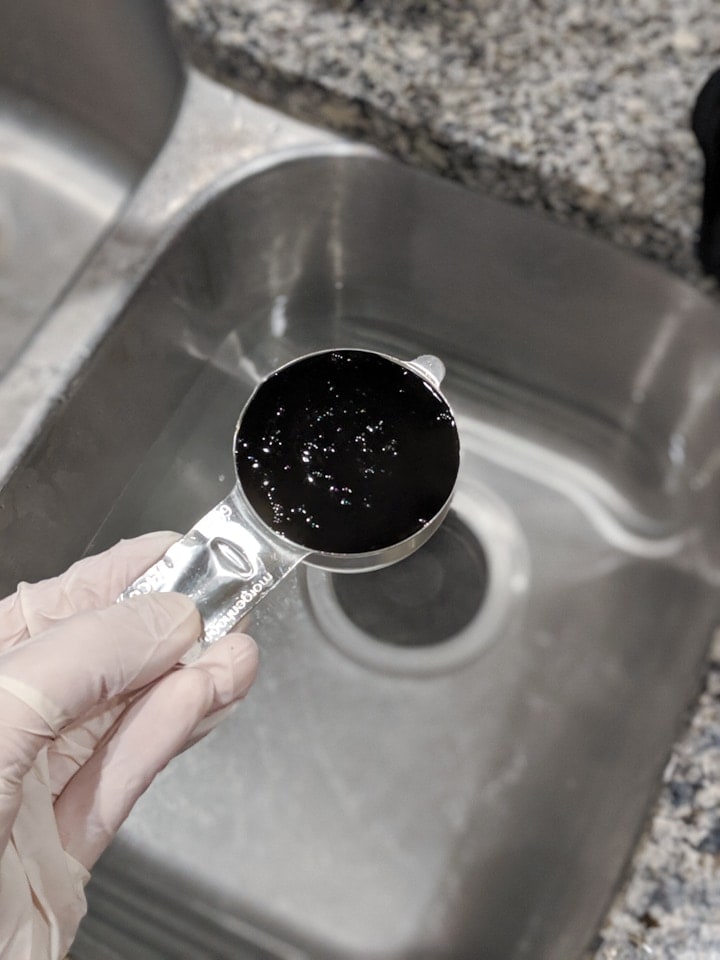 prepping the black dye bath in a sink