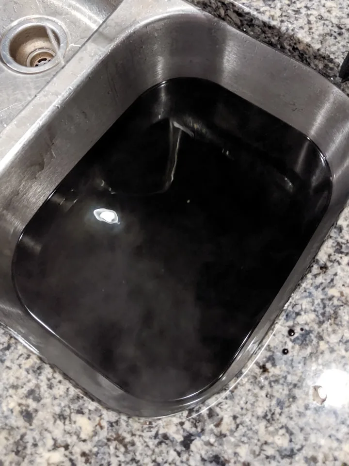 black dye bath in a sink