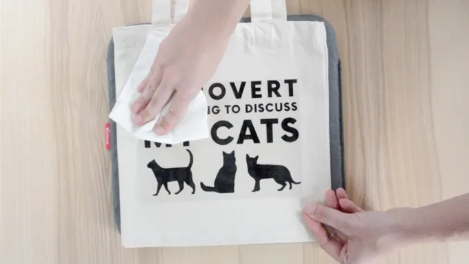 tote bag with a design on it saying introvert but willing to discuss my cats