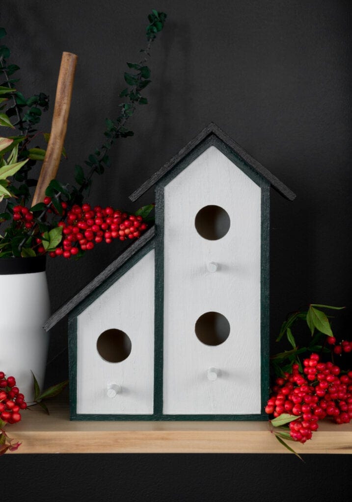 painted wooden birdhouse on a shelf