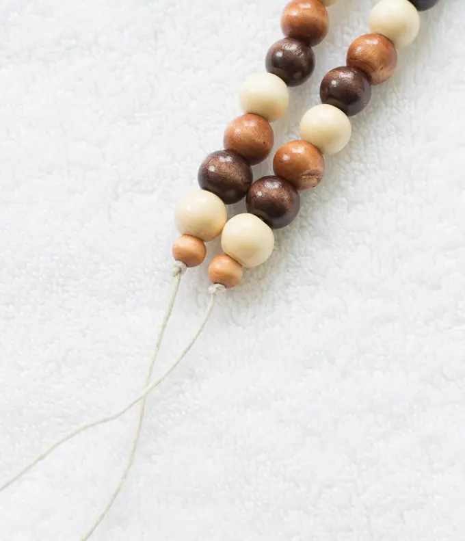 tying off the tope ends on wooden beads