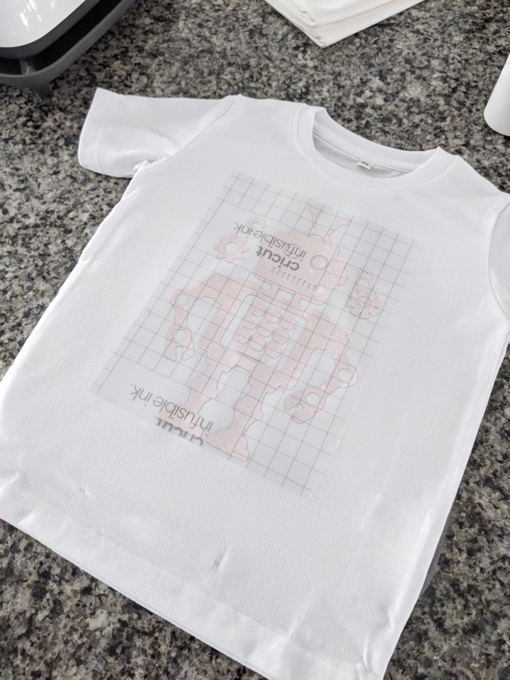 transferring an infusible ink design of a robot onto a toddler t-shirt blank
