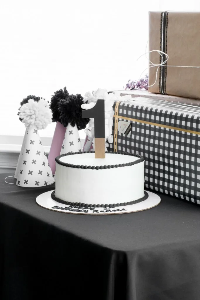 gorgeous black and white cake with a number 1 cake topper