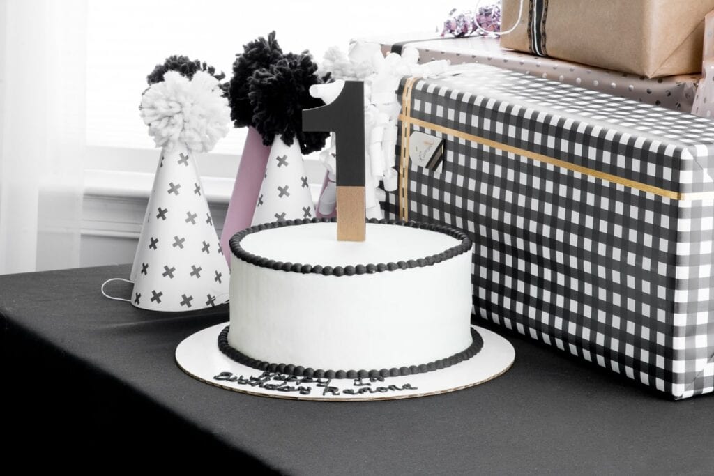 gorgeous black and white cake with a number 1 cake topper