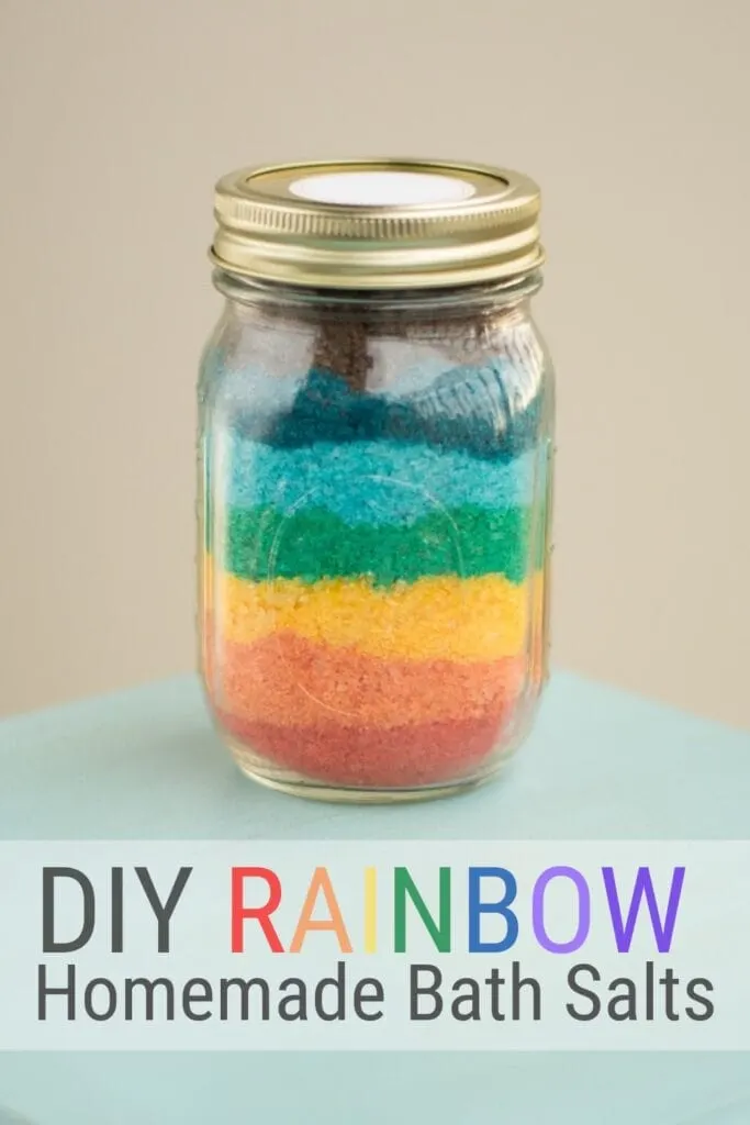 pinnable graphic with a picture of finished rainbow homemade bath salts and text overlay