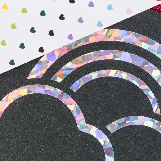 piece of paper with holographic vinyl in the shape of a rainbow