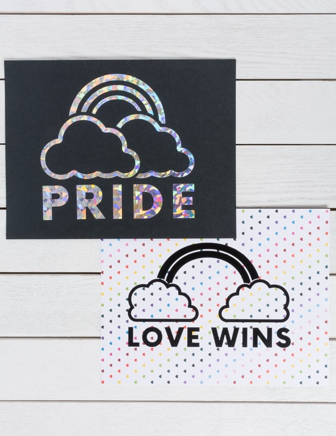 pieces of paper that say PRIDE in holographic vinyl with a rainbow and LOVE WINS on rainbow hearts