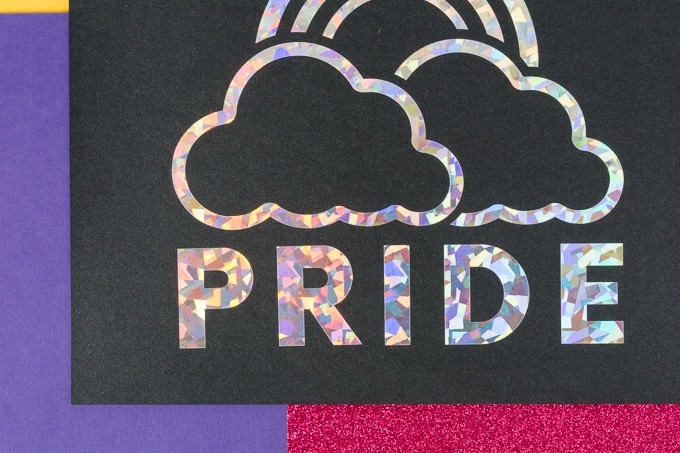 piece of paper with holographic writing that says PRIDE