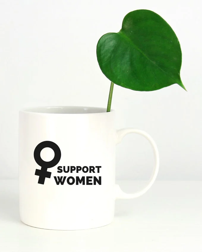feminist coffee mug that says support women with a female symbol