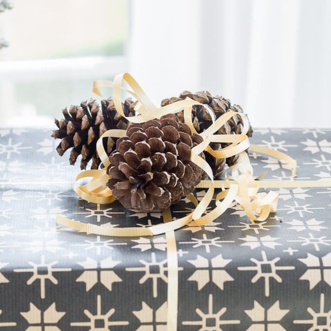 presents adorned with ribbons and pine cones