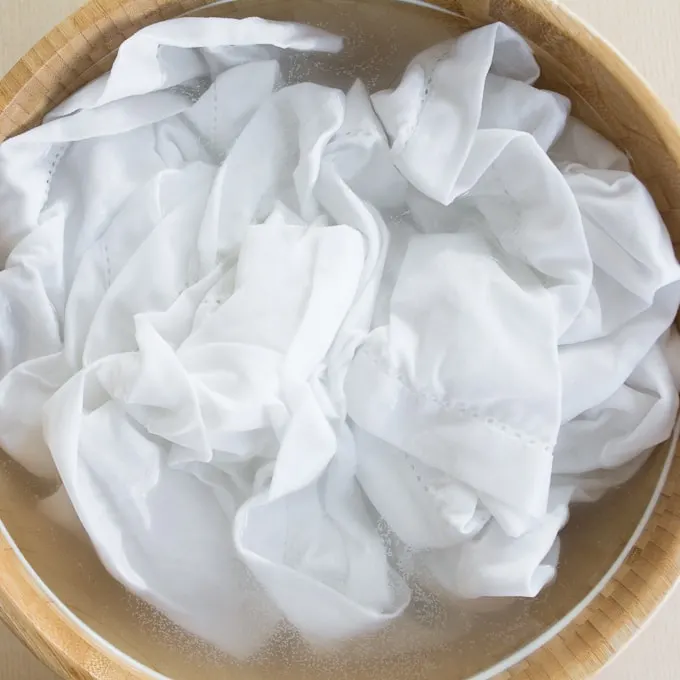 white cotton napkin submerged in soda ash water