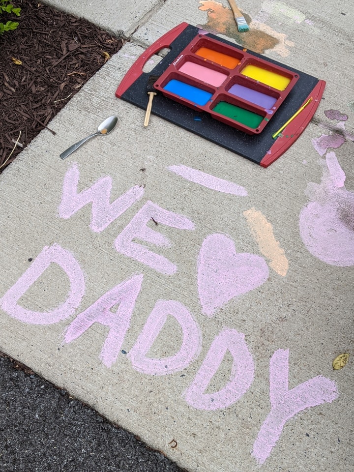 painting DIY sidewalk chalk paint using a paint brush
