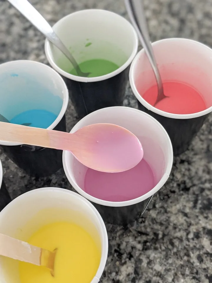 adding food coloring mix to corn starch and water mixtures