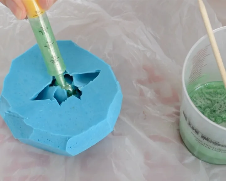 pouring resin into a silicone mold