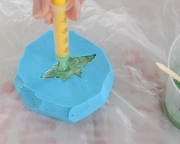 squirting resin into a silicone mold