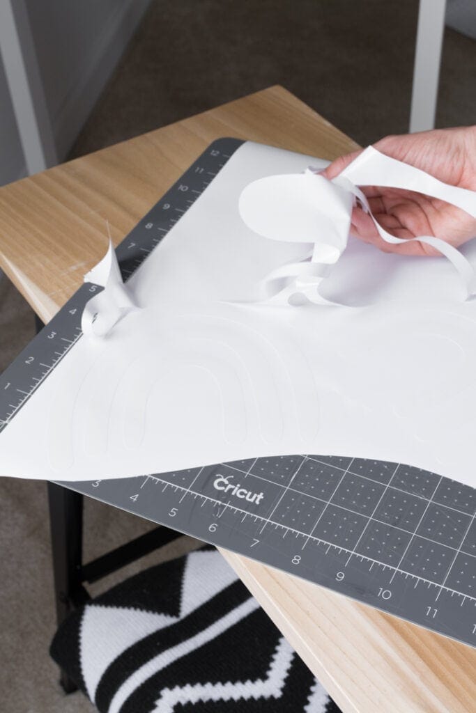 removing negative space after cutting vinyl on a Cricut machine to make DIY wall decals