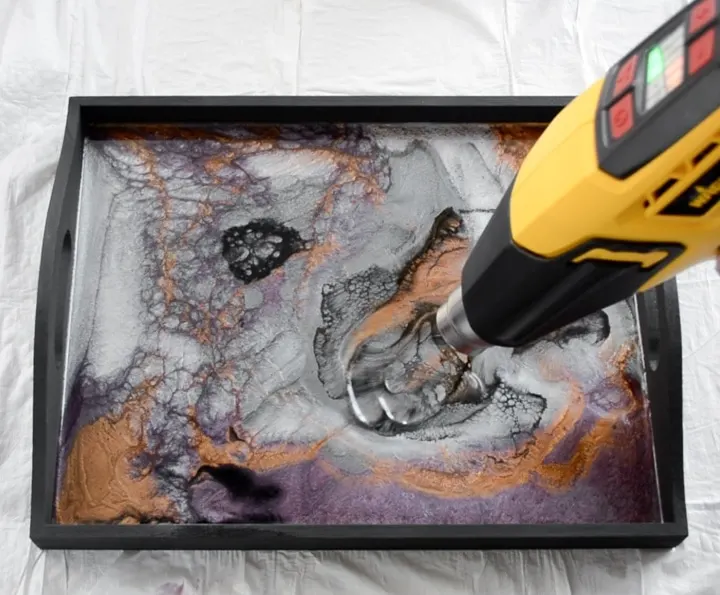 using a heat gun to blow air bubbles out of resin