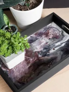 DIY resin and wood serving tray with a plant on it