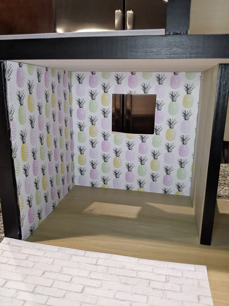 adding the scrapbook paper to a dollhouse for wallpaper