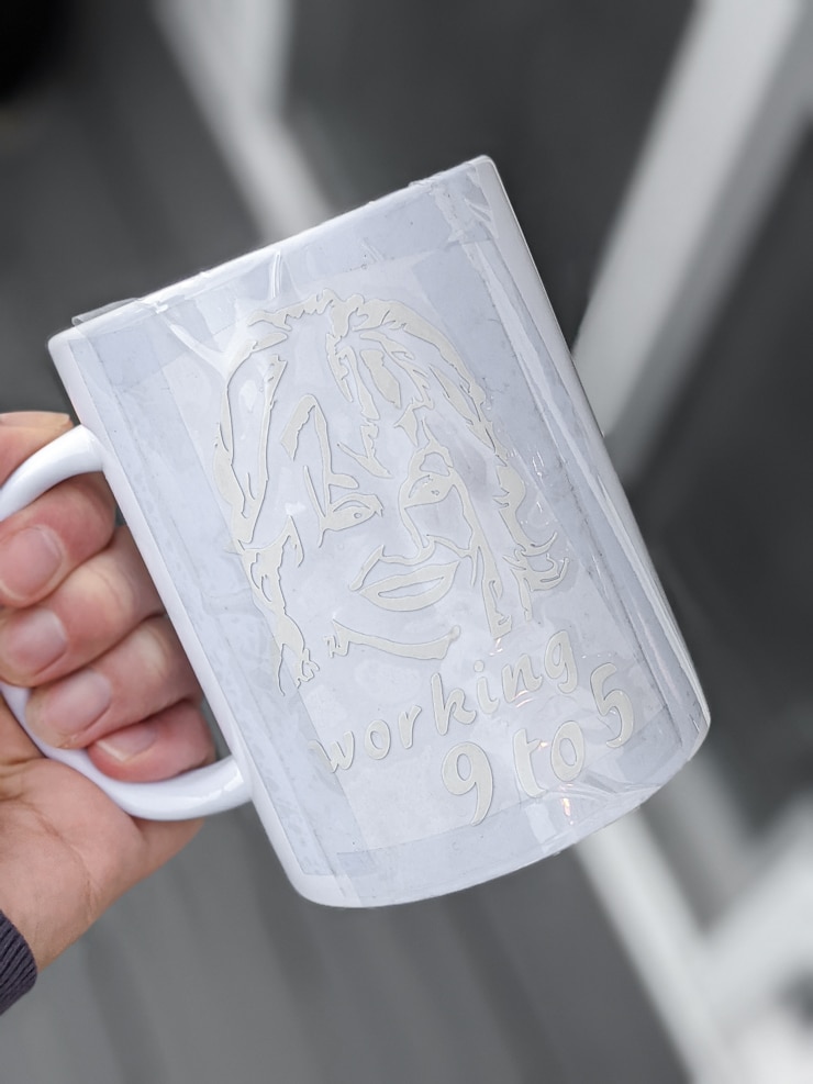 Dolly Parton svg file cut out of Cricut Infusible Ink and taped onto a mug blank