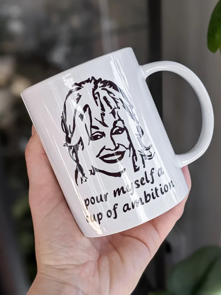 Cricut mug blank customized with a Dolly Parton svg file and a Cricut Mug Press