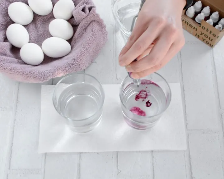 prepping the dye baths to dye eggs with food coloring