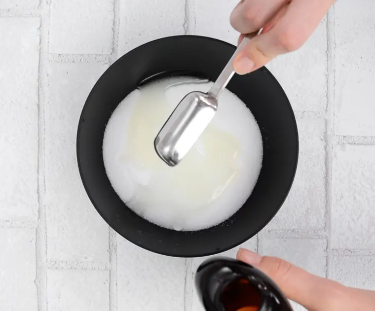 adding coconut oil to salt in a bowl
