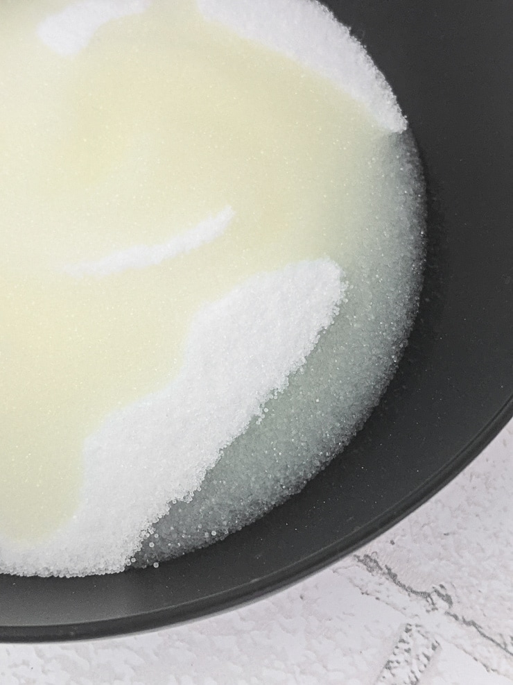 adding coconut oil to salt in a bowl