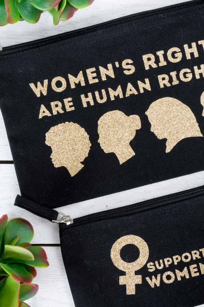 zippered pouches with "women's rights are human rights" and "support women" decals on them