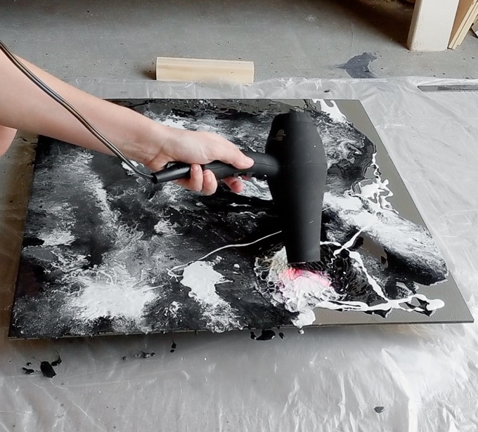 using a hair dryer to blow around the resin 