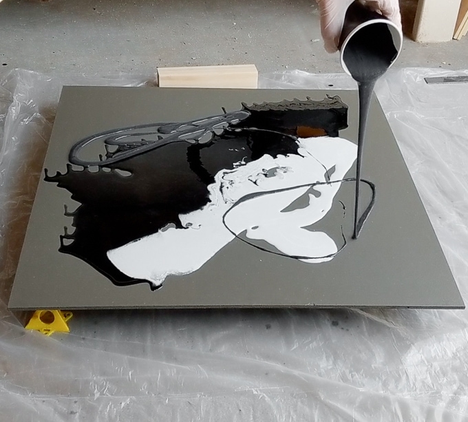 pouring colored resin onto the plywood