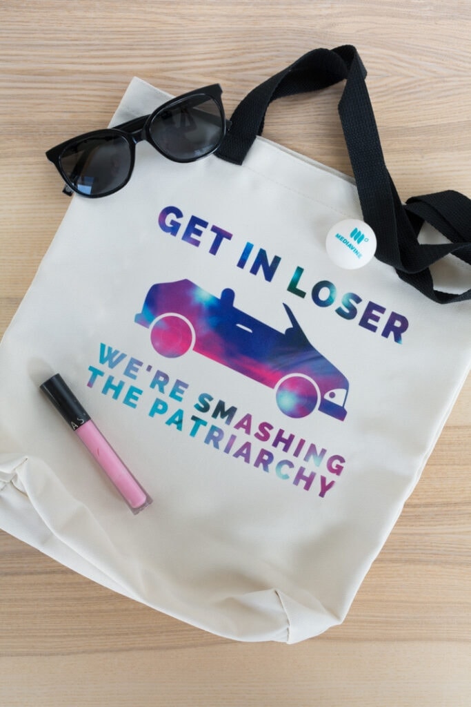 cricut infusible ink feminist tote bag that says get in loser we're smashing the patriarchy 