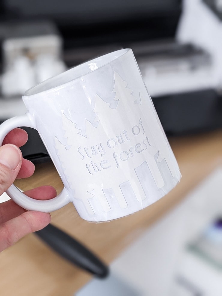 Infusible Ink Cricut mug that says "stay out of the forest"