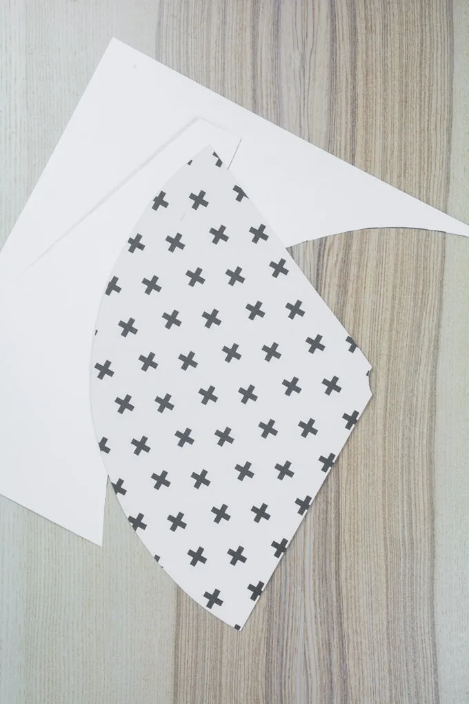 scrapbook paper cut out into a shape for a party hat