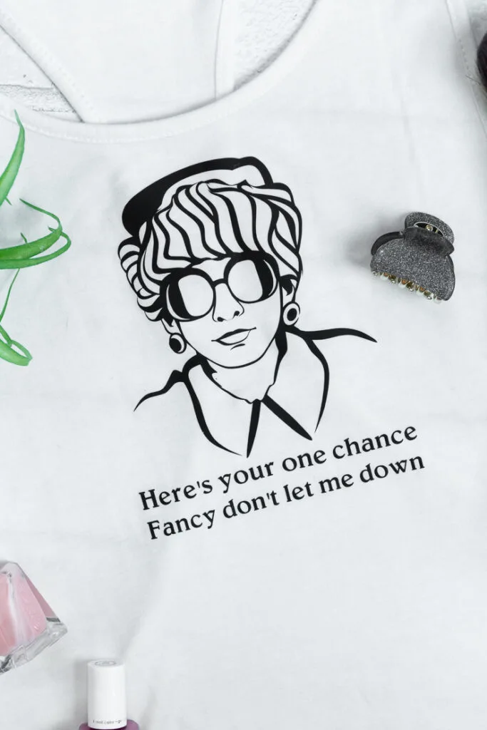 white tank top with a design that is a picture of reba mcentire dressed as fancy and the text here's your one chance fancy don't let me down
