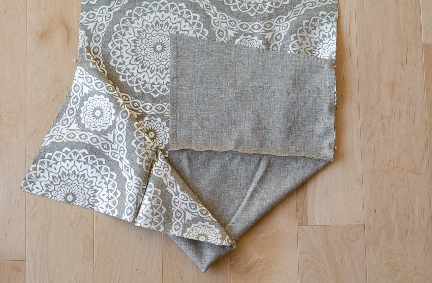 sewing pieces of fabric together to make a sewing machine cover