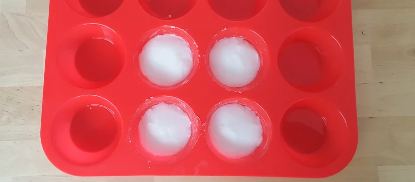 DIY Shower Steamers pressed into a silicone cupcake holder