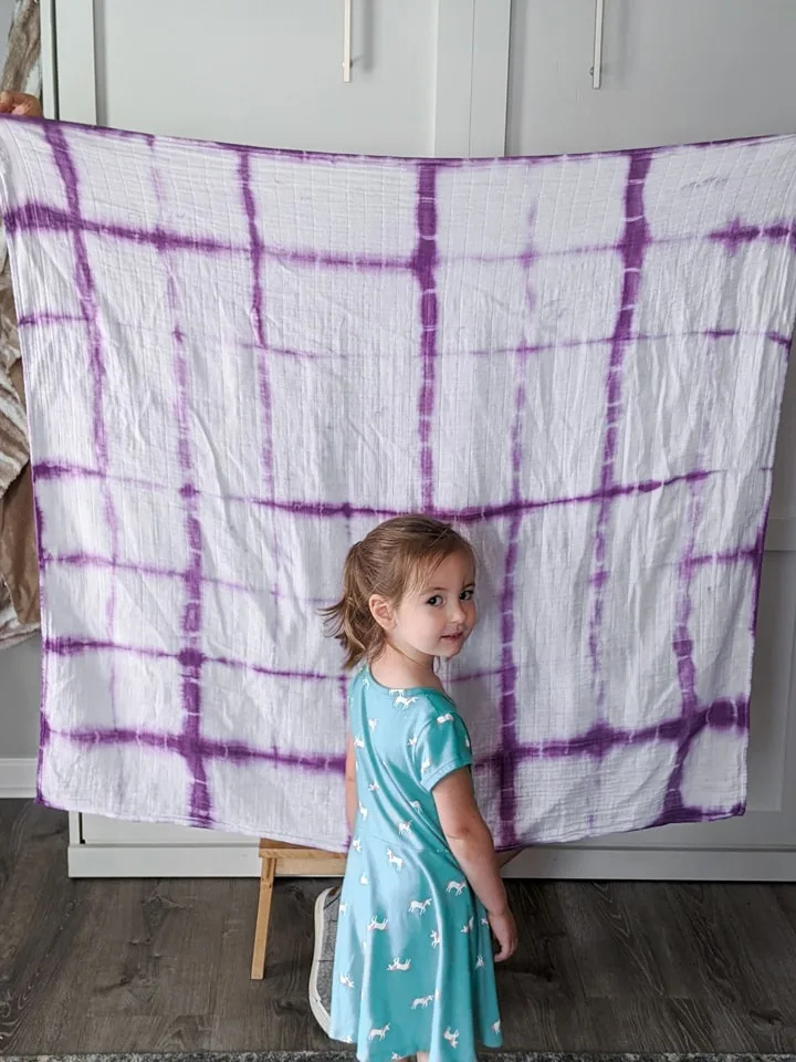 little girl with a shibori dyed blanket