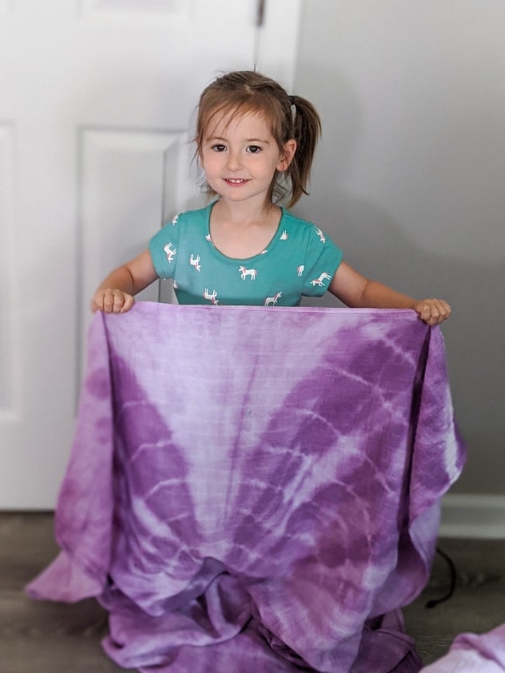 little girl with a shibori dyed blanket