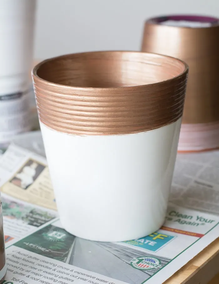 painting a clay pot using acrylic paint