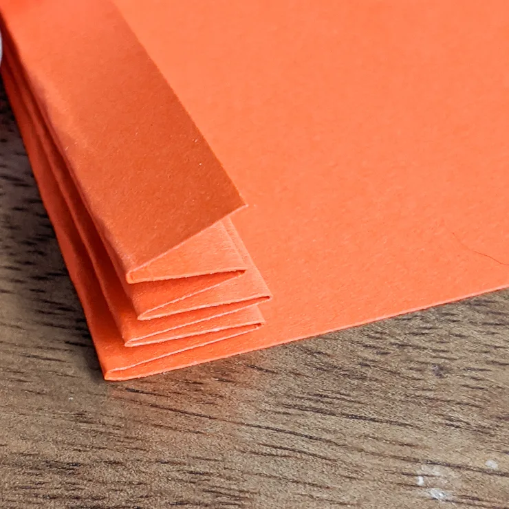 folding a piece of orange paper