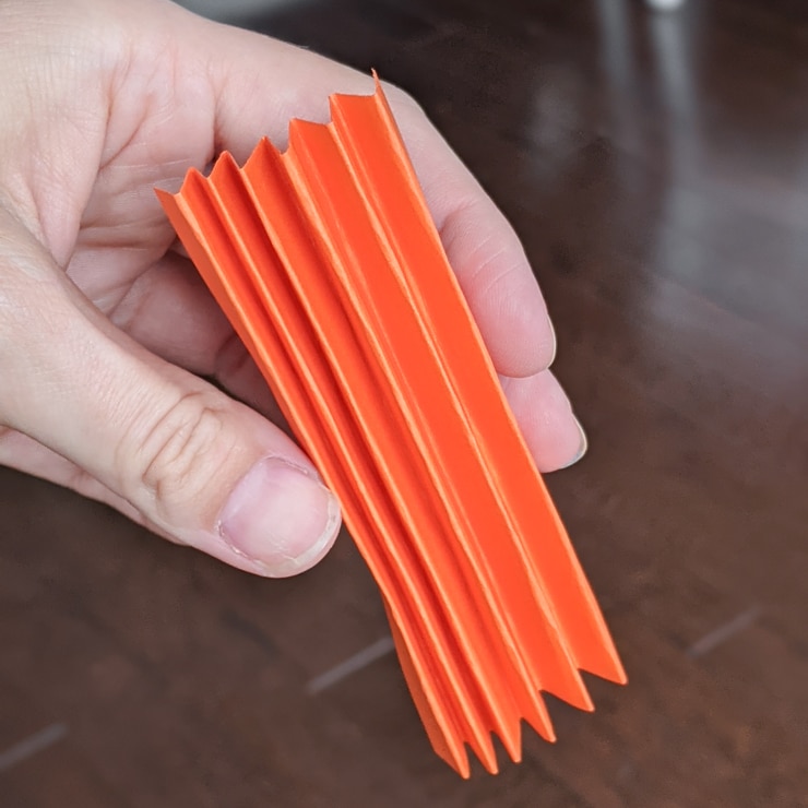 folding a piece of orange paper