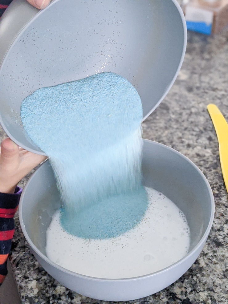 mixing all ingredients together to make DIY sand slime