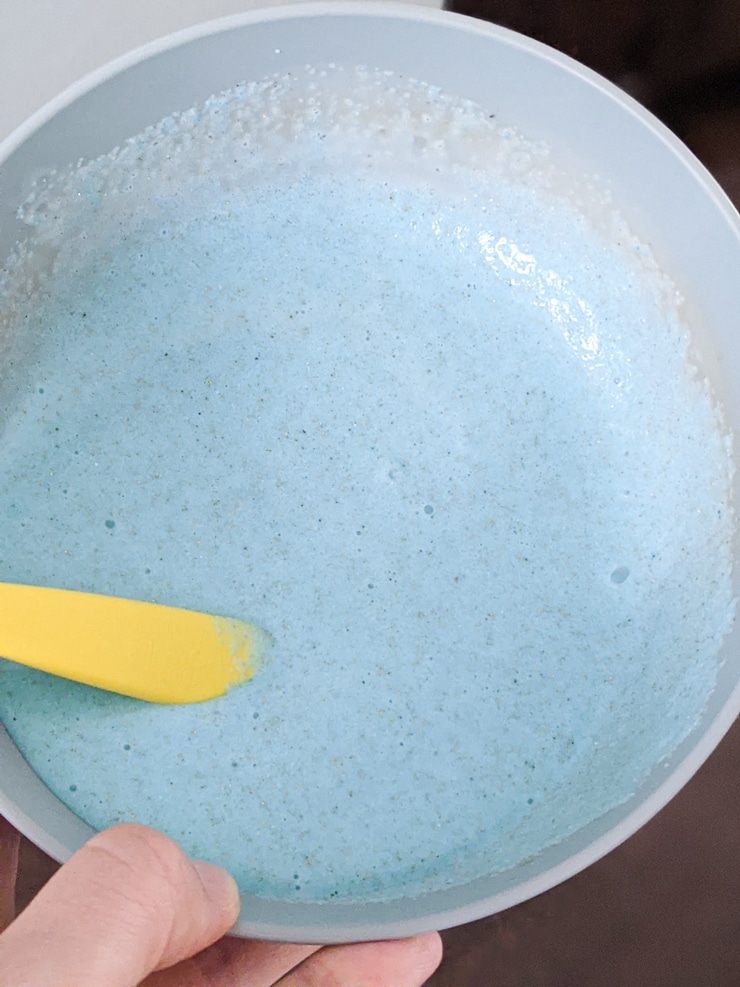 mixing all ingredients together to make DIY sand slime