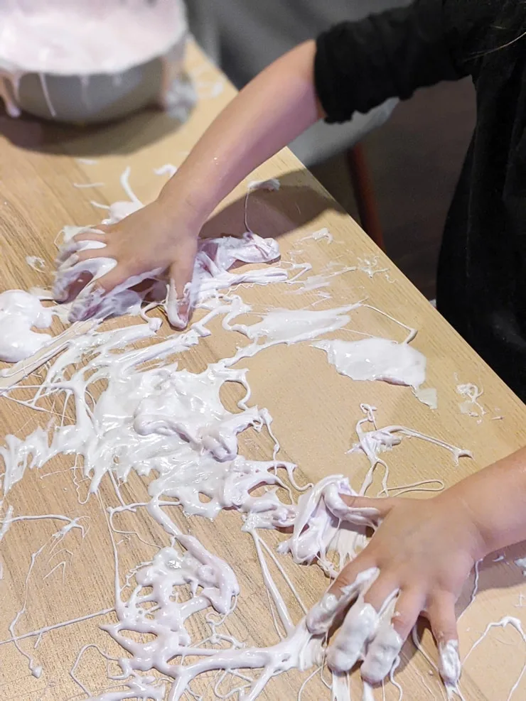 mixing glue water and shaving cream to make DIY fluffy slime